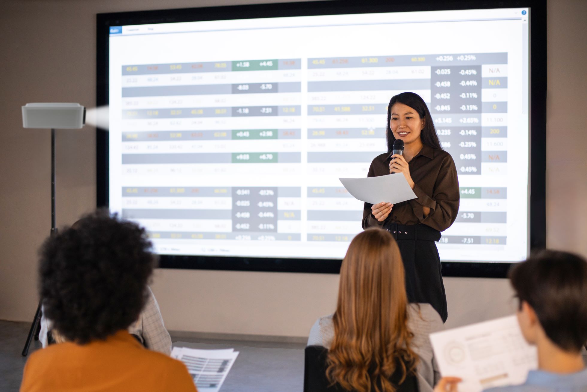 A person standing in front of a large screen Description automatically generated