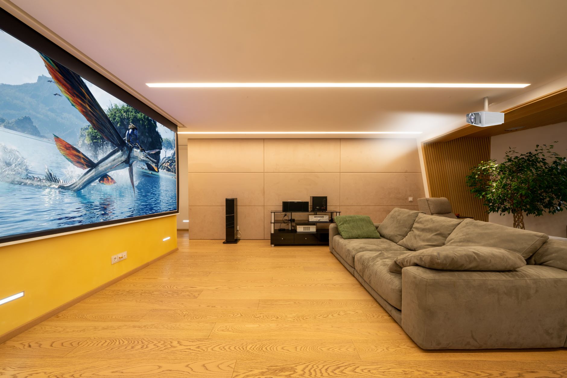 A room with a large screen and couch Description automatically generated